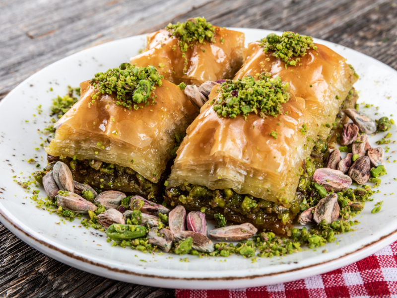 An exquisite arrangement of Baklava, showcasing the artful layers of flaky phyllo pastry, premium nuts, and a signature honey drizzle. Meticulously crafted with the finest ingredients, this Baklava is a harmonious blend of tradition and indulgence. Elegant packaging adds to the visual appeal, making it a perfect gift or a luxurious addition to your dessert selection.